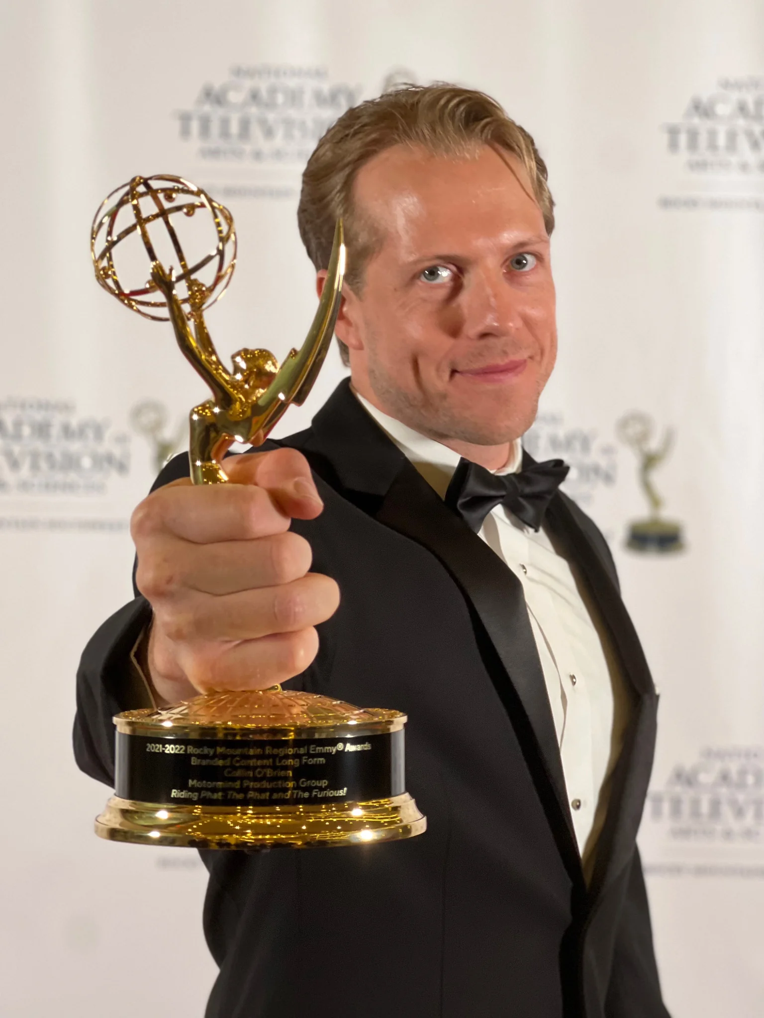 Collin O’Brien holding an Emmy award